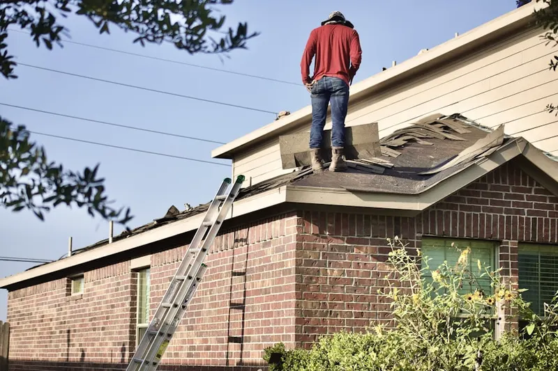 Professional roofer working on a residential roof in Plantation Crossing